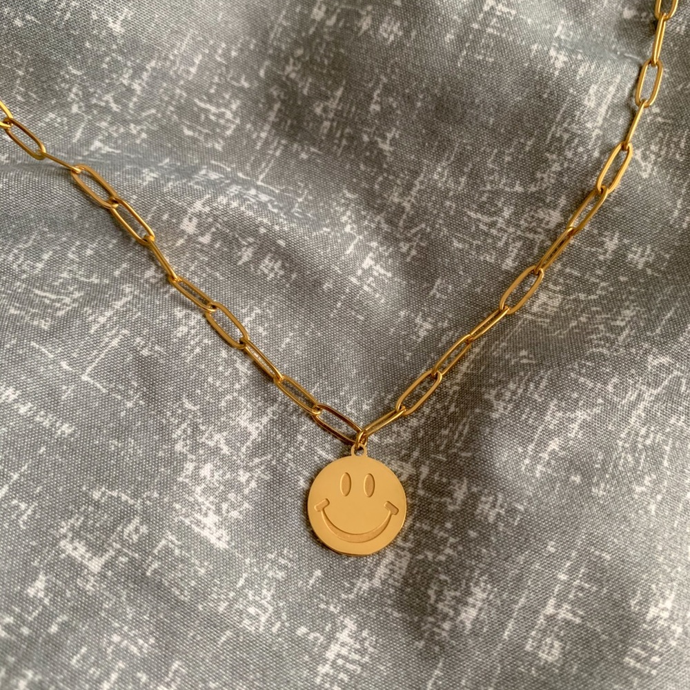 Gold smiley face necklace